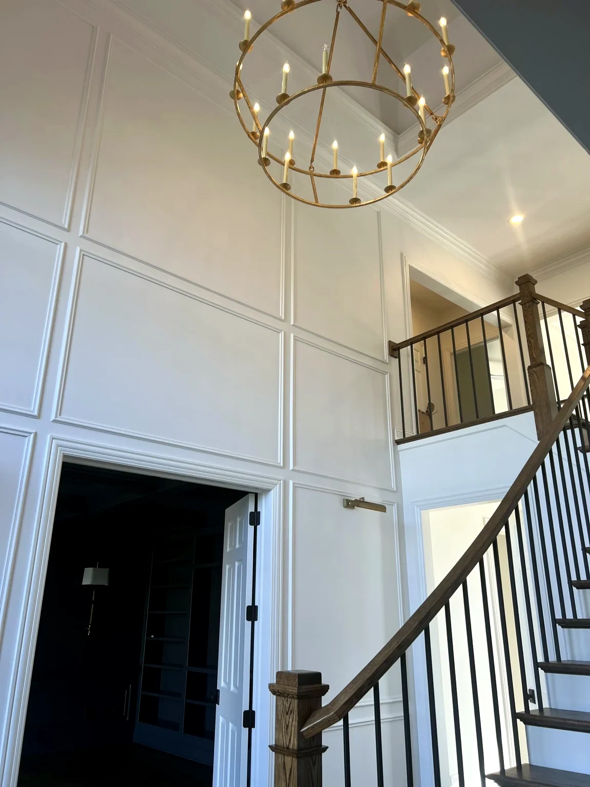 Tall stair hall wainscoting and millwork
