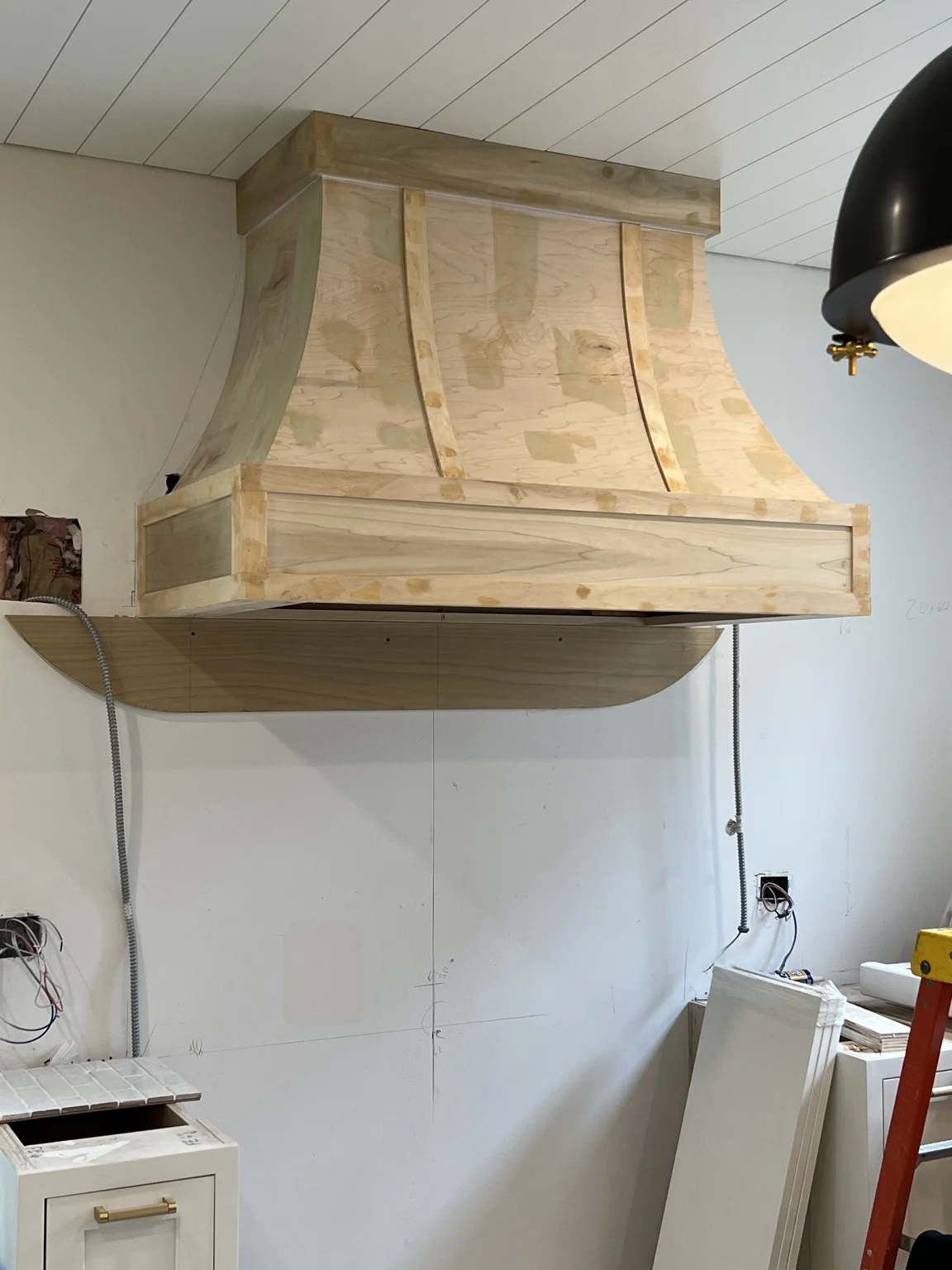 Raw wood hood installed in kitchen
